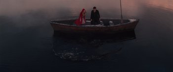 Movie still from “Red Riding Hood” (2011), directed by Catherine Hardwicke – A man and a woman sitting on a boat in the water; Wide shot, High angle