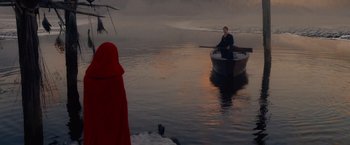 Movie still from “Red Riding Hood” (2011), directed by Catherine Hardwicke – A man rowing a boat on a body of water; Extreme Wide shot, Over the shoulder angle