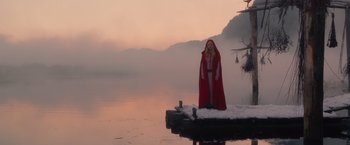 Movie still from “Red Riding Hood” (2011), directed by Catherine Hardwicke – A woman standing on a dock in the water; Wide shot, Low angle