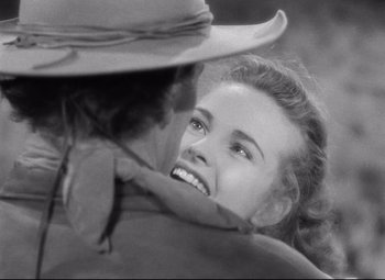 Movie still from “Red River” (1948), directed by Howard Hawks – A black - and - white photo of a woman and a cowboy; Close Up shot, Over the shoulder angle