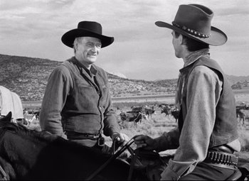 Movie still from “Red River” (1948), directed by Howard Hawks – Two men talking to each other on a horse; Medium shot, Over the shoulder angle