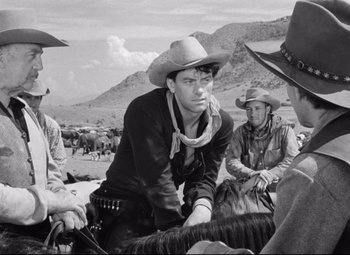 Movie still from “Red River” (1948), directed by Howard Hawks – A group of men sitting on top of a horse; Medium shot, Over the shoulder angle