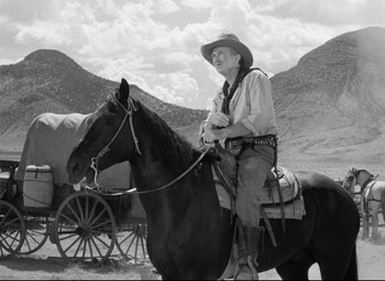 Movie still from “Red River” (1948), directed by Howard Hawks – An old photo of a man on a horse; Wide shot, Low angle