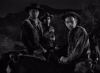 Movie still from “Red River” (1948), directed by Howard Hawks – A group of men on horses in a black - and - white photo; Medium shot, Low angle