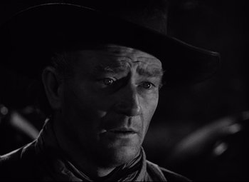 Movie still from “Red River” (1948), directed by Howard Hawks – A black and white photo of a man wearing a cowboy hat; Close Up shot, Low angle