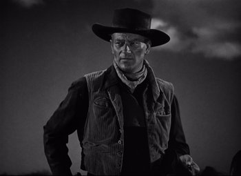 Movie still from “Red River” (1948), directed by Howard Hawks – A man wearing a hat and a jacket; Medium shot, Low angle
