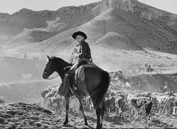Movie still from “Red River” (1948), directed by Howard Hawks – An old photo of a man on a horse; Wide shot, Low angle