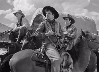 Movie still from “Red River” (1948), directed by Howard Hawks – A group of men riding on the back of horses; Medium shot, Low angle
