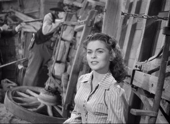 Movie still from “Red River” (1948), directed by Howard Hawks – An old black and white photo of a woman and a man; Medium shot, Low angle