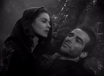 Movie still from “Red River” (1948), directed by Howard Hawks – A man and a woman are sitting on the ground; Close Up shot, High angle