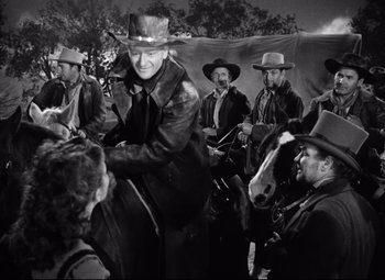 Movie still from “Red River” (1948), directed by Howard Hawks – A group of men wearing hats and leather jackets; Medium shot, Low angle