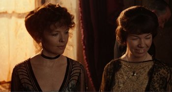 Movie still from “Reds” (1981), directed by Warren Beatty – Two women standing next to each other in front of a window; Close Up shot, Over the shoulder angle