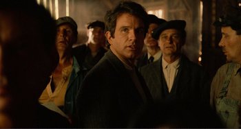 Movie still from “Reds” (1981), directed by Warren Beatty – A group of men standing next to each other in a room; Close Up shot, Over the shoulder angle