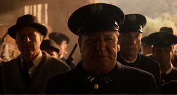 Movie still from “Reds” (1981), directed by Warren Beatty – A group of men standing next to each other wearing hats; Close Up shot, Low angle