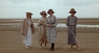 Movie still from “Reds” (1981), directed by Warren Beatty – A group of women standing on top of a sandy beach; Wide shot, High angle