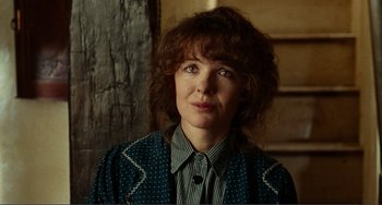 Movie still from “Reds” (1981), directed by Warren Beatty – A person wearing a shirt and jacket; Close Up shot, Over the shoulder angle