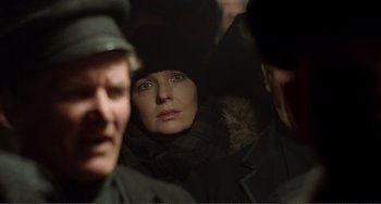 Movie still from “Reds” (1981), directed by Warren Beatty – A woman in a black coat and a man in a black hat; Close Up shot, Over the shoulder angle