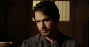 Movie still from “Reds” (1981), directed by Warren Beatty – A person wearing a jacket; Close Up shot, Over the shoulder angle