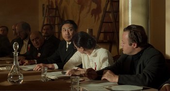 A group of people sitting at a table with plates of food on it