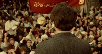 Movie still from “Reds” (1981), directed by Warren Beatty – A crowd of people are gathered around a speaker; Wide shot, High angle