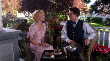 Movie still from “Reefer Madness: The Movie Musical” (2005), directed by Andy Fickman – A man and a woman sitting at an outdoor table; Medium shot, High angle