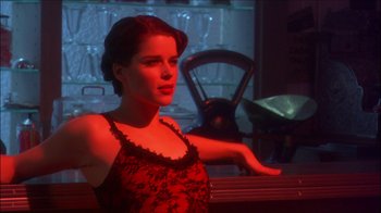 Movie still from “Reefer Madness: The Movie Musical” (2005), directed by Andy Fickman – A beautiful woman in a red dress posing for the camera; Close Up shot, Over the shoulder angle