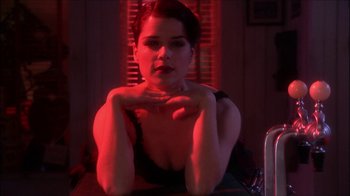 Movie still from “Reefer Madness: The Movie Musical” (2005), directed by Andy Fickman – A woman sitting at a table with her arms crossed; Close Up shot, Low angle