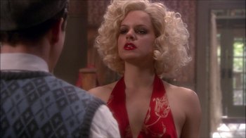 Movie still from “Reefer Madness: The Movie Musical” (2005), directed by Andy Fickman – A woman with blonde hair and a red dress; Close Up shot, Over the shoulder angle