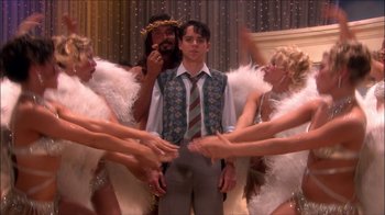 Movie still from “Reefer Madness: The Movie Musical” (2005), directed by Andy Fickman – A group of people dressed up as angels and a man; Medium shot, High angle