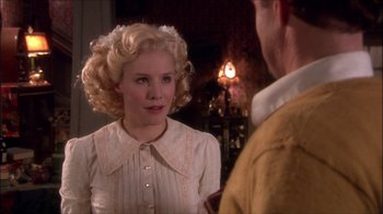 Movie still from “Reefer Madness: The Movie Musical” (2005), directed by Andy Fickman – A woman with blonde curly hair wearing a white dress; Close Up shot, Over the shoulder angle