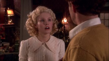 Movie still from “Reefer Madness: The Movie Musical” (2005), directed by Andy Fickman – A woman in a white blouse is talking to a man in a yellow shirt; Close Up shot, Over the shoulder angle