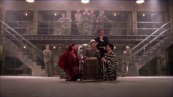 Movie still from “Reefer Madness: The Movie Musical” (2005), directed by Andy Fickman – A group of men and women dressed in jail uniforms; Wide shot, High angle