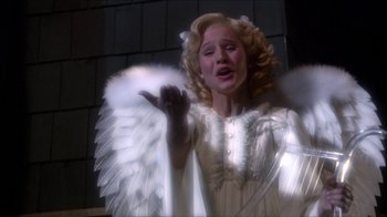 Movie still from “Reefer Madness: The Movie Musical” (2005), directed by Andy Fickman – A woman dressed as an angel is singing a song; Medium shot, Low angle