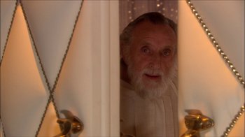 Movie still from “Reefer Madness: The Movie Musical” (2005), directed by Andy Fickman – An old man with a beard looking out a window; Close Up shot, High angle