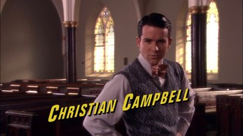 Movie still from “Reefer Madness: The Movie Musical” (2005), directed by Andy Fickman – A man standing in front of stained glass windows; Medium shot, Low angle