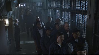 Movie still from “Reindeer Games” (2000), directed by John Frankenheimer – A group of people standing next to each other in a room; Wide shot, High angle