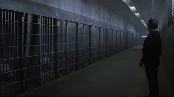 Movie still from “Reindeer Games” (2000), directed by John Frankenheimer – A long row of metal cages in a building; Extreme Wide shot, High angle
