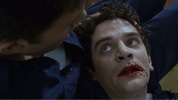 Movie still from “Reindeer Games” (2000), directed by John Frankenheimer – A person laying on the ground with blood on his face; Close Up shot, High angle