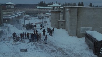 Movie still from “Reindeer Games” (2000), directed by John Frankenheimer – A group of people standing in the snow near a building; Extreme Wide shot, High angle