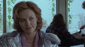 Movie still from “Reindeer Games” (2000), directed by John Frankenheimer – A person wearing a jacket near a window; Close Up shot, Over the shoulder angle