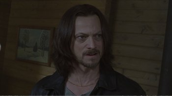 Movie still from “Reindeer Games” (2000), directed by John Frankenheimer – A person with long black hair; Close Up shot, Over the shoulder angle