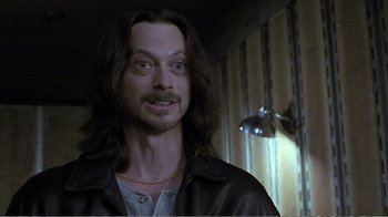 Movie still from “Reindeer Games” (2000), directed by John Frankenheimer – A person with long black hair; Close Up shot, Over the shoulder angle