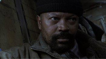 Movie still from “Reindeer Games” (2000), directed by John Frankenheimer – A person wearing a jacket and a hat; Close Up shot, High angle