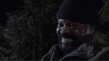 Movie still from “Reindeer Games” (2000), directed by John Frankenheimer – A person with a beard smiling; Close Up shot, Low angle