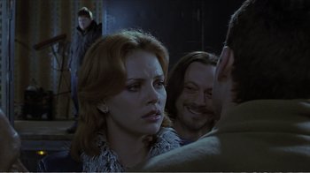 Movie still from “Reindeer Games” (2000), directed by John Frankenheimer – A group of people sitting in a room; Medium shot, Over the shoulder angle