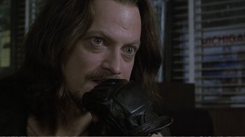 Movie still from “Reindeer Games” (2000), directed by John Frankenheimer – A person with long hair wearing a glove; Close Up shot, Over the shoulder angle