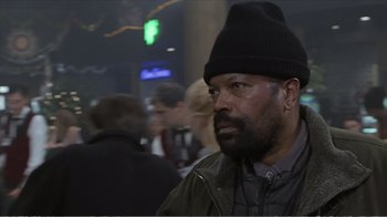 Movie still from “Reindeer Games” (2000), directed by John Frankenheimer – A man wearing a black hat and a green jacket; Close Up shot, Low angle