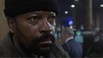 Movie still from “Reindeer Games” (2000), directed by John Frankenheimer – A person with a beard wearing a hat; Close Up shot, Low angle