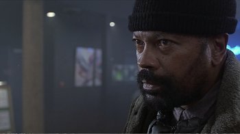 Movie still from “Reindeer Games” (2000), directed by John Frankenheimer – A person with a beard wearing a hat; Close Up shot, Low angle