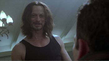 Movie still from “Reindeer Games” (2000), directed by John Frankenheimer – A man with long hair looking at himself in the mirror; Close Up shot, Over the shoulder angle